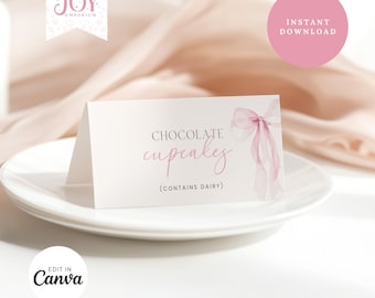 May include: Printable table card with a pink watercolor bow and the text "Chocolate cupcakes (contains dairy)".