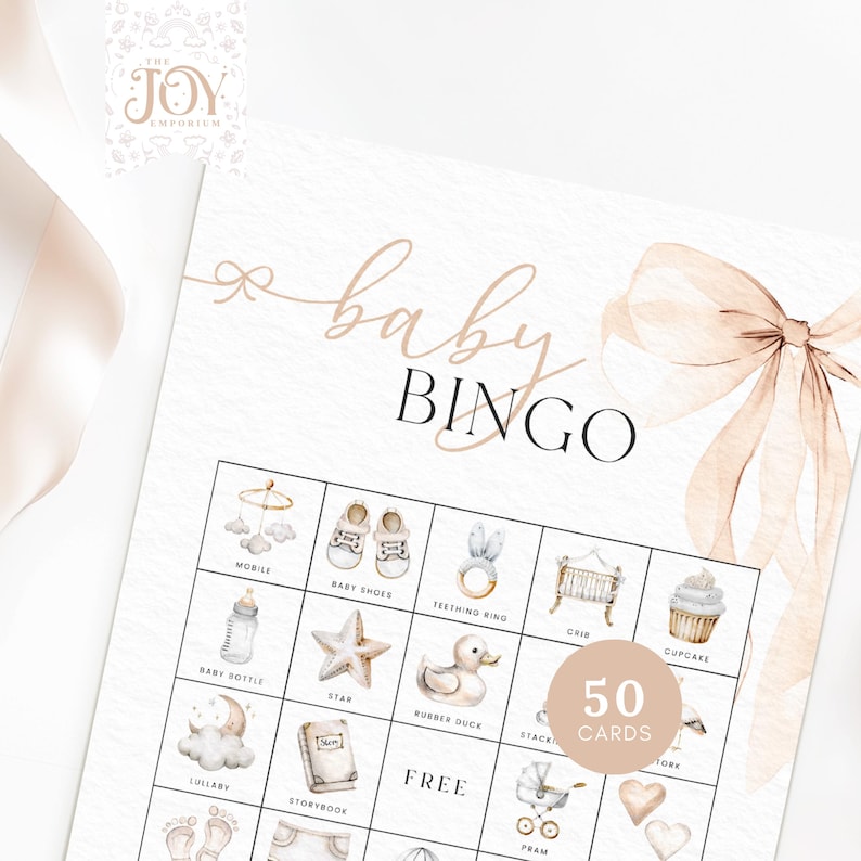 May include: A printable baby bingo card with a pink bow on top. The card has a grid of 25 squares with images of baby items like a mobile, baby shoes, a teething ring, a crib, a baby bottle, a star, a rubber duck, a stack of books, a lullaby, a storybook, a pram, a heart, and a cupcake. The card also has the words "baby bingo" and "free" printed on it. There is a circle in the bottom right corner that says "50 cards".