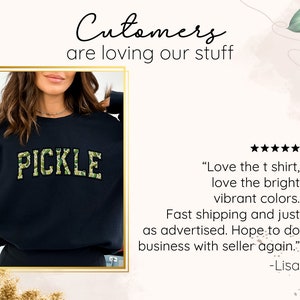 a woman wearing a black sweater with the words pickle on it