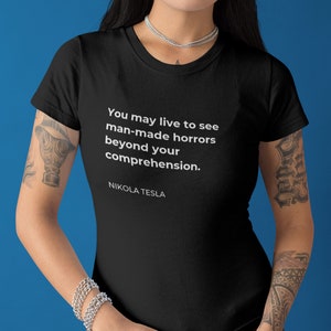 May include: Black t-shirt with a white quote by Nikola Tesla: "You may live to see man-made horrors beyond your comprehension."