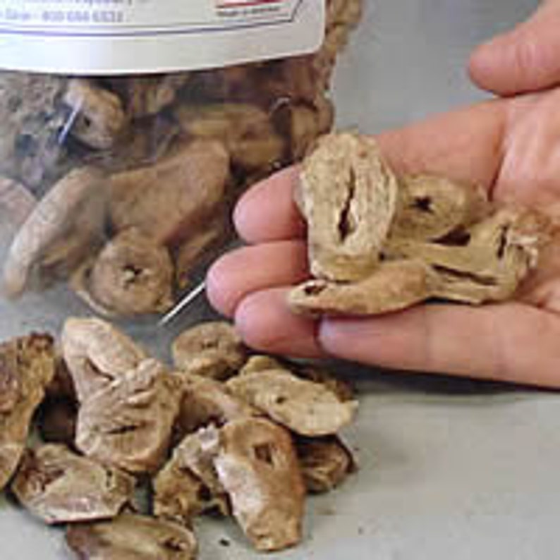 May include: A bag of dried, light brown, irregularly shaped pieces of ginger root.