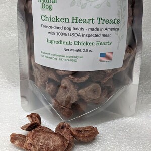 May include: A resealable bag of freeze-dried chicken heart dog treats. The bag is labeled "GG Natural Dog Chicken Heart Treats" and "Made in America". The bag contains 2.5 ounces of treats. The treats are brown and have a natural, meaty texture.
