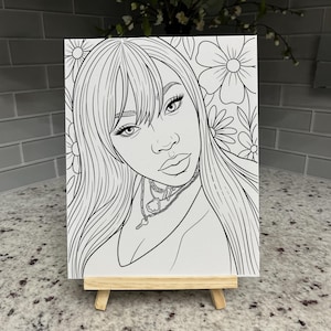 May include: A black and white line art illustration on a rectangular canvas featuring a portrait of a person with long hair, bangs, and layered chain necklaces. The background is filled with large floral outlines. The canvas rests on a wooden easel.