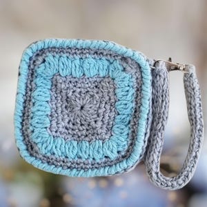 Elegante bolso de mano, monedero o billetera. Un dije para bolso o llavero. Un accesorio de moda para bolsos. Lleva cómodamente auriculares, teléfonos plegables o monedas.