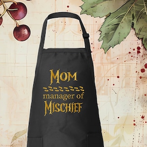 May include: Black apron with a gold print that says "MOM manager of MISCHIEF" with a trail of footprints.