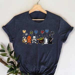 May include: A dark blue t-shirt with a graphic of Star Wars characters holding heart-shaped balloons. The characters include Darth Vader, R2-D2, Chewbacca, Yoda, and Stormtrooper.