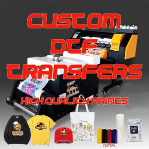 May include: A close-up of a DTF printing machine with a variety of printed items, including t-shirts, a tote bag, a hat, and a roll of transfer paper. The machine is used to create custom designs on fabric using a direct-to-film printing process. The image also includes a bag of DTF powder and a set of CMYKW inks.
