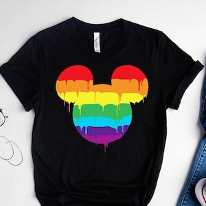 May include: Black t-shirt with a rainbow Mickey Mouse head graphic. The graphic is dripping with rainbow colors.