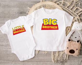 May include: A white short-sleeved baby bodysuit and a white short-sleeved t-shirt. The bodysuit features the text LITTLE BROTHER in yellow and red, while the t-shirt displays the text BIG BROTHER in yellow and red, both in a block font.