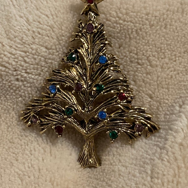 Vintage LIA Christmas tree brooch. antiqued gold toned metal with sparkling rhinestones.