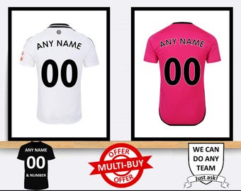 May include: Two soccer jerseys, one white and one pink, with the text "ANY NAME" and "00" on the back. The jerseys are displayed on a wooden shelf with a sign that says "OFFER MULTI-BUY OFFER" and another sign that says "WE CAN DO ANY TEAM Just ask!"