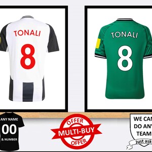 May include: Two framed images of football jerseys with the name "TONALI" and the number "8" on the back. The jersey on the left is black and white striped, while the jersey on the right is green. The images are displayed on a wooden shelf with a black and white jersey with the number "00" and the text "ANY NAME & NUMBER" below the left image. A red and white multi-buy offer sticker is below the left image. A white shield with the text "WE CAN DO ANY TEAM Just ask!" is below the right image.