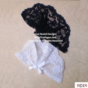 May include: Two lace fabric pieces, one black and one white, with a scalloped edge. The black lace is folded in a fan shape. The white lace has a bow in the center.