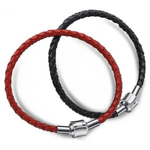 May include: Two braided leather bracelets, one red and one black, with silver magnetic clasps.