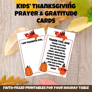 May include: Two Thanksgiving prayer and gratitude cards with turkey and pumpkin illustrations. The cards read "I am thankful for..." and "Thank you, God." The cards are on a wooden surface with fall leaves. The text "Kids' Thanksgiving Prayer & Gratitude Cards" is at the top.