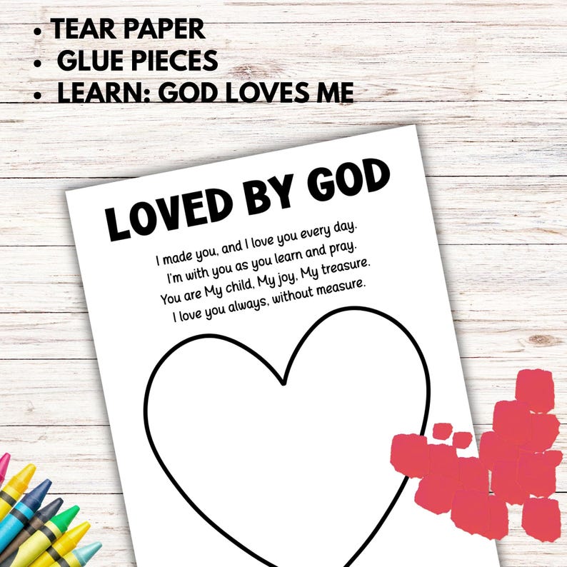 May include: A white paper with the text "LOVED BY GOD" and a heart outline. The text includes a poem about love and faith. Instructions at the top say "TEAR PAPER, GLUE PIECES, LEARN: GOD LOVES ME". Crayons are visible in the corner.
