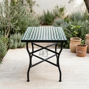 May include: Square outdoor side table with a black metal frame and a tiled top. The tabletop features a green and white diamond pattern. The table is approximately 24 inches square and stands about 20 inches tall.