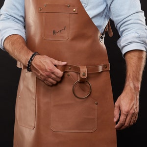 May include: A handmade, wooden cutting board with a natural finish. The board features a juice groove and a handle for easy carrying. Dimensions are approximately 16 inches long, 10 inches wide, and 0.75 inches thick.