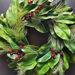 Magnolia winter Christmas wreath for your front door, made of traditional magnolia leaves, pine needles, red berries, perfect holiday decor