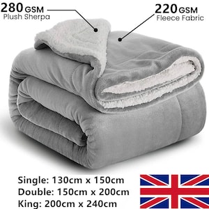 May include: A folded grey blanket with a plush Sherpa lining and fleece fabric. Available in single (130cm x 150cm), double (150cm x 200cm), and king (200cm x 240cm) sizes. The blanket features 280 GSM Plush Sherpa and 220 GSM Fleece Fabric.