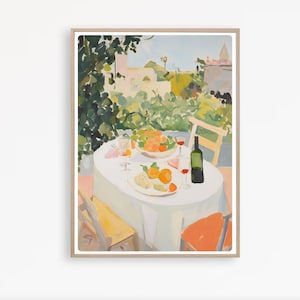 May include: An art print of a table set for a meal outdoors. The table is covered with a white tablecloth and set with a plate of food, fruit, wine glasses, and a bottle of wine. The background features lush greenery and buildings.