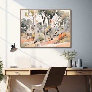 May include: A watercolor painting of a landscape with trees and a path. The trees are a variety of greens and browns, and the path is a light brown. The painting is framed in a light wood frame.