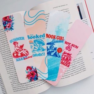 May include: Four colorful bookmarks with summer-themed designs. Each bookmark features illustrations of women, text, and floral accents. The phrases include "Summer Ready Reading!", "I'm Booked for the Summer", "Book Girl Summer", and "Hot Sun Potter Stories."
