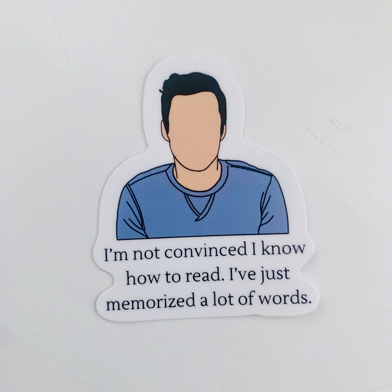 May include: A sticker featuring a cartoon illustration of a person with a blue shirt and the text "I'm not convinced I know how to read. I've just memorized a lot of words."