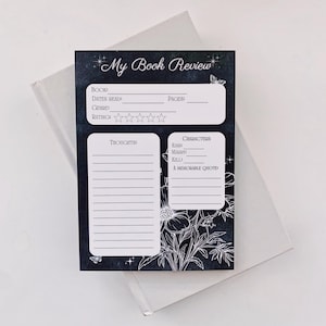 May include: A black and white printable book review template with a floral design. The template includes sections for book title, dates read, pages, genre, rating, thoughts, characters, and a memorable quote.