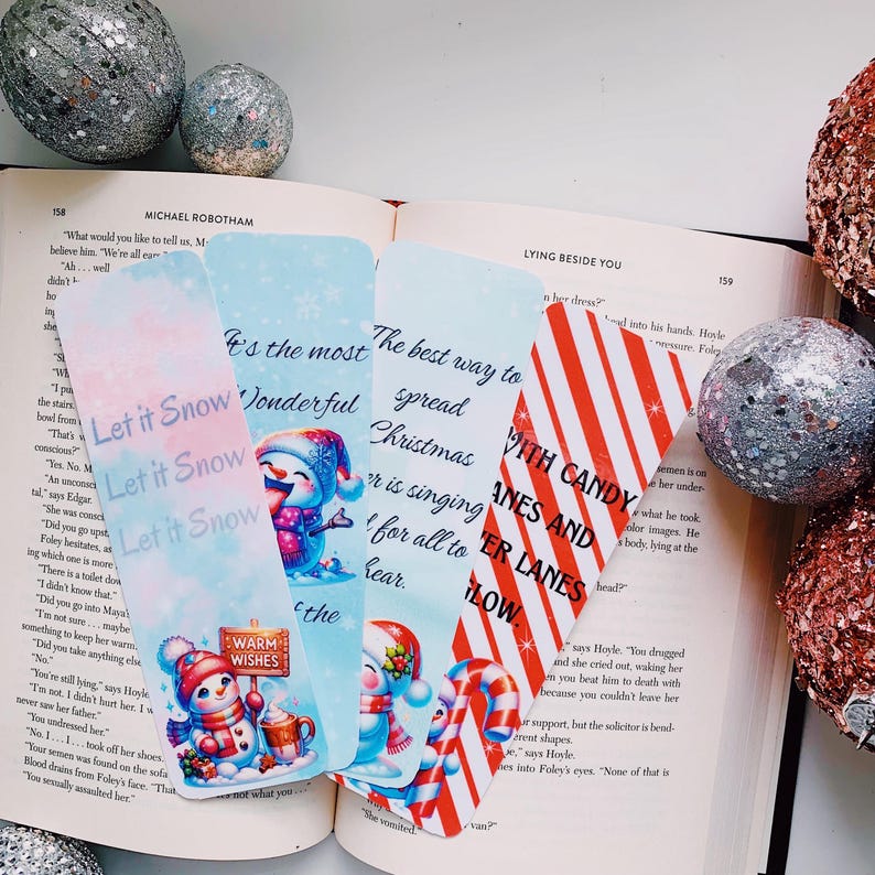 May include: Four colorful bookmarks with winter themes. The bookmarks feature illustrations of snowmen, candy canes, and Christmas trees. The text on the bookmarks reads "Let it Snow", "It's the most wonderful time of the year", "The best way to spread Christmas cheer", and "With Candy Canes and Winter Lanes".