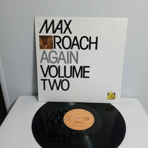 May include: A black vinyl record with a white and orange label. The label says "Max Roach Again Volume Two" and "F-Jazz".