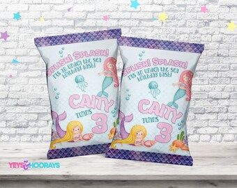May include: Two mermaid-themed party favor bags. The bags feature the text "SPLISH! SPLASH! It's an under the sea birthday bash!" and "CAITY TURNS 3". The design includes mermaids, jellyfish, and aquatic elements.