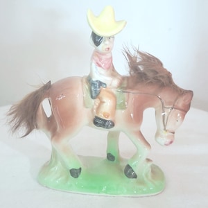 Set of Two Horse Figurines, One Porcelain other with Furry Mane, and Tail with a Cowboy