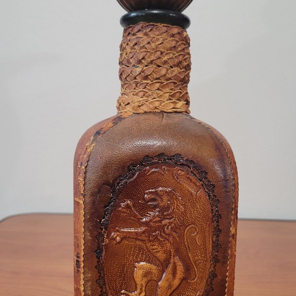 Vintage Tooled Leather Wrapped Italian Square Liquor Bottle With Embossed Lion on Front Green Bottle Within