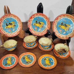 Vintage 1940s Puppy Dog Designed Tin Child's Tea Set Well Loved Rusty Gold Red and Blue with Frisky Pup in Center 12 Piece Set Made in USA