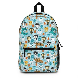 May include: A blue backpack with a colorful pattern of cartoon characters, including penguins, monkeys, and octopuses. The characters are swimming in a blue and white wave pattern.