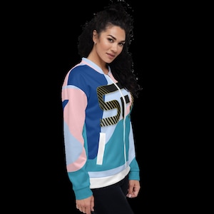 May include: A blue, pink, and teal bomber jacket with a black and gold "5" graphic on the front.