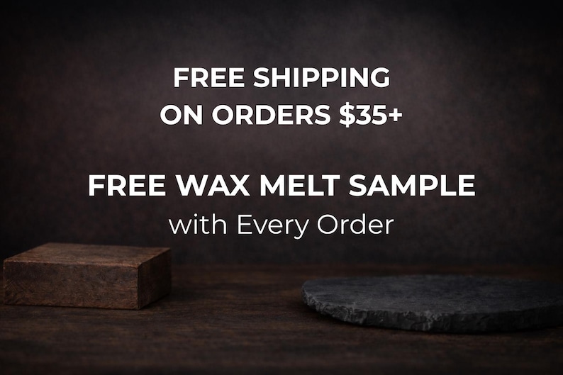 May include: Dark brown background with white text that reads "FREE SHIPPING ON ORDERS $35+" and "FREE WAX MELT SAMPLE with Every Order." A small, dark brown rectangular block and a dark gray, oval-shaped stone are in the foreground.