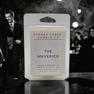 May include: A wax melt package in a clear plastic container. The label reads "STONEY CREEK CANDLE CO" and "THE MAVERICK". It also states "HAND POURED IN NOBLESVILLE, IN" and the net weight is 2.5 oz (70.9 g).