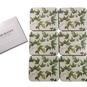 May include: A set of six rectangular coasters with a botanical ivy design. The coasters feature green ivy leaves and vines on a cream background. The coasters are displayed with a white box that reads "jason COASTERS".