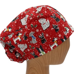 May include: Red scrub hat with a festive pattern of dogs and snowflakes. The hat is made of a soft, comfortable fabric and is perfect for nurses, doctors, and other healthcare professionals.