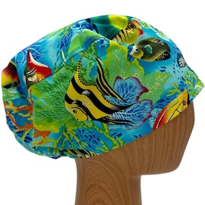 May include: A blue, green, and yellow surgical scrub hat with a colorful fish and coral reef pattern.