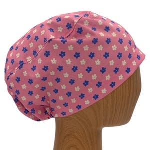 May include: Pink scrub hat with a white and blue floral pattern.