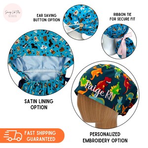 May include: A blue and green surgical scrub hat with a dinosaur print and the name "Paige RN" embroidered on it. The hat has a ribbon tie for a secure fit and a satin lining option. It also has an ear-saving button option.