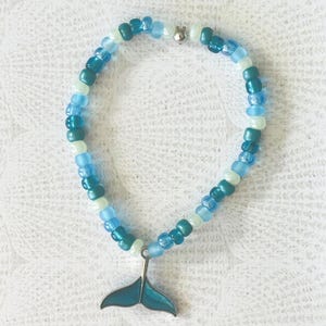 Mermaid Bracelet with glass beads and metal mermaid/whale tail charm. 7&quot; stretchy bracelet, blue, mermaid, whale tail, ocean lover gifts