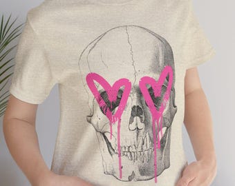 Skull Heart Tee, Unisex Graphic T-Shirt, Alternative Fashion, Gift for Goths, Casual, Skull with pink dripping paint heart eyes, skull shirt