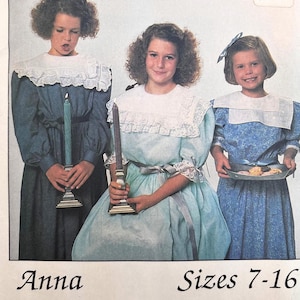 May include: Three girls in vintage dresses with white lace collars. One holds a lit candle, another a candle, and the third carries a tray of treats. The dresses are in shades of blue and green. Text reads "Anna Sizes 7-16".