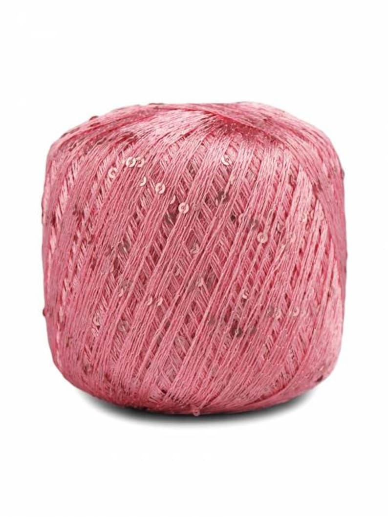 Pu&ograve; includere: Un gomitolo di filato rosa con paillettes intrecciate nel filato.