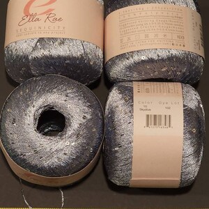May include: Four spools of silver and blue sequined yarn with the brand name Ella Rae and the product name Sequinicity. The yarn is 295 yards (275 metres) and is made in China.