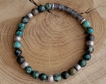 Op de afbeelding: Een turquoise en bruine kralen armband met zilveren accenten. De armband is gemaakt van natuurlijke stenen en is een stijlvol accessoire voor elke gelegenheid.